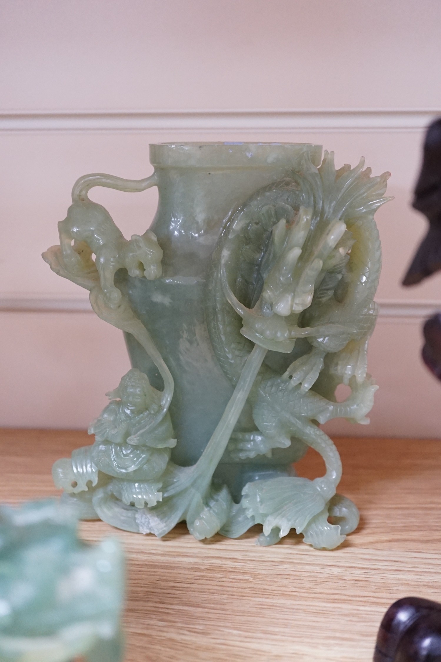 Four Chinese bowenite jade carvings - two mythical beasts, a censer and cover and a ‘dragon’ vase and cover, largest 28cm long